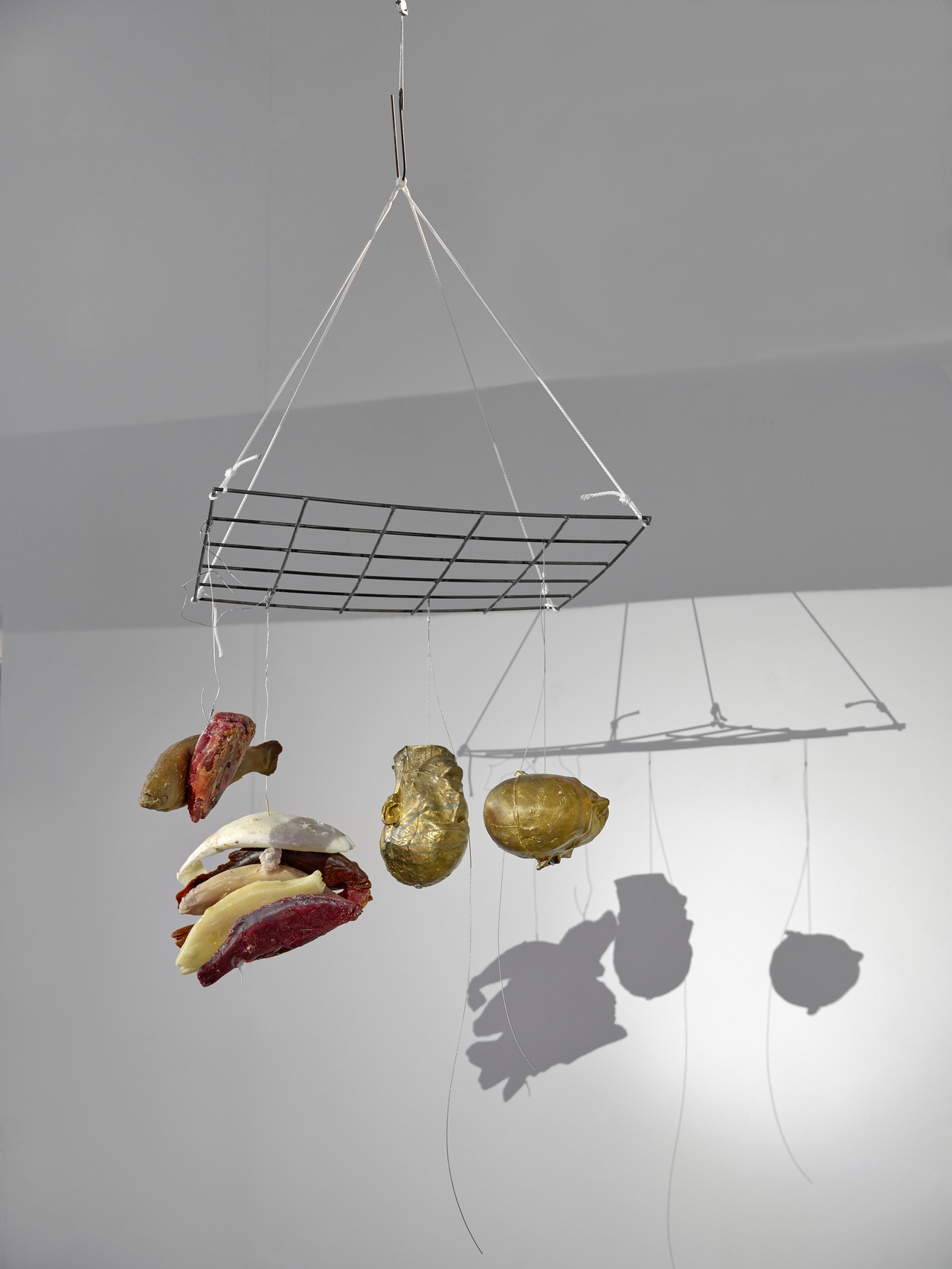 Bruce Nauman, „2 bronze heads hung with bundled damaged or packrat chewn wax fish“, 2025