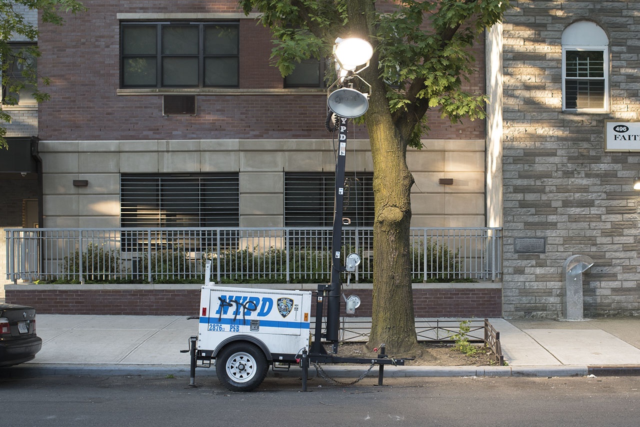 Mobile floodlight of the NYPD at Gates Ave, Bedford–Stuyvesant, Brooklyn. These extremely bright lights are part of a citywide policing infrastructure used in Black neighborhoods and Housing Developments.
